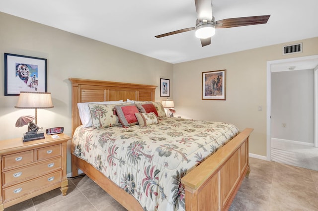 bedroom with light tile patterned flooring, baseboards, and a ceiling fan