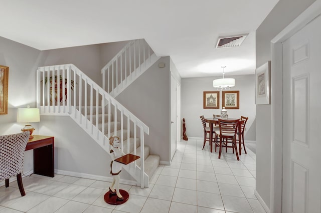 staircase with tile patterned floors and baseboards