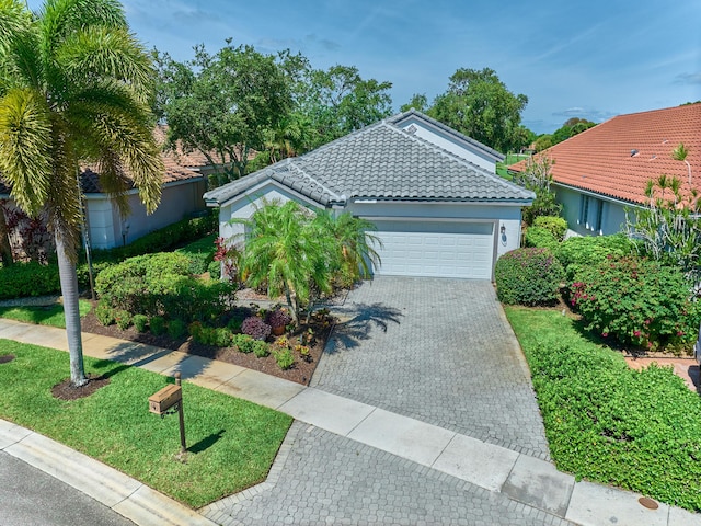 5455 S Fountains Dr S, Lake Worth, FL 33467 - ranch-style home with an attached garage, a tiled roof, decorative driveway, and stucco siding