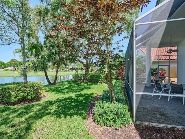5455 S Fountains Dr S, Lake Worth, FL 33467 - view of grassy yard with a water view, ceiling fan, and glass enclosure