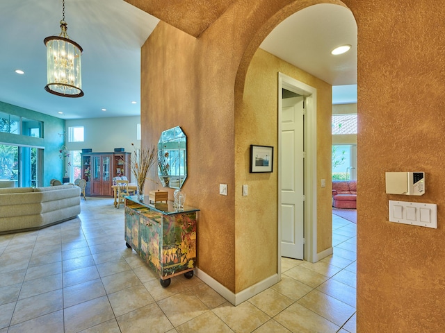 5455 S Fountains Dr S, Lake Worth, FL 33467 - hallway with a textured wall, light tile patterned floors, a chandelier, recessed lighting, and baseboards