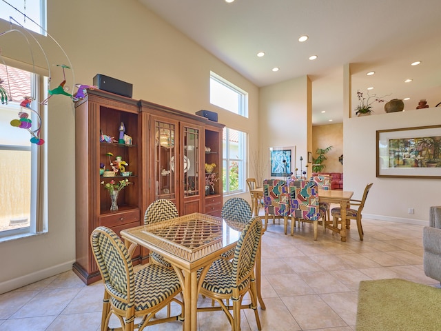 5455 S Fountains Dr S, Lake Worth, FL 33467 - dining space featuring a towering ceiling, light tile patterned floors, recessed lighting, and baseboards