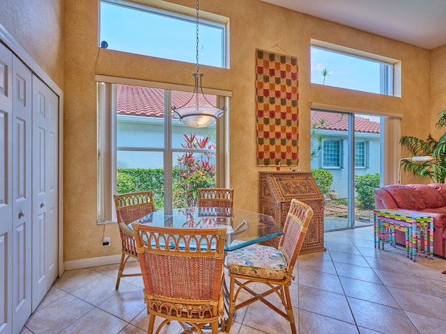 5455 S Fountains Dr S, Lake Worth, FL 33467 - dining room with plenty of natural light, a textured wall, a high ceiling, light tile patterned floors, and baseboards
