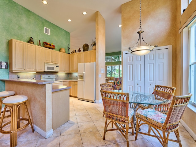 5455 S Fountains Dr S, Lake Worth, FL 33467 - kitchen with white appliances, a towering ceiling, baseboards, recessed lighting, and a peninsula