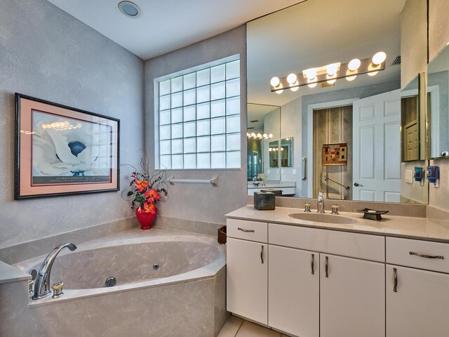 5455 S Fountains Dr S, Lake Worth, FL 33467 - full bath featuring a whirlpool tub, vanity, and tile patterned flooring
