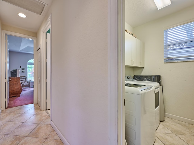 5455 S Fountains Dr S, Lake Worth, FL 33467 - clothes washing area with washer and clothes dryer, cabinet space, light tile patterned floors, and baseboards