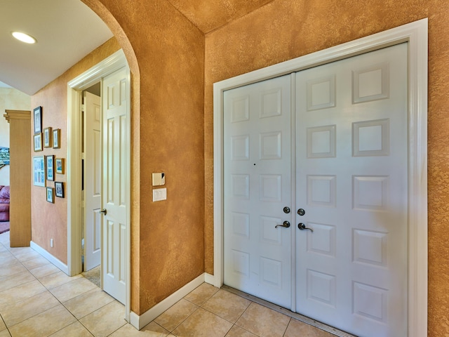 5455 S Fountains Dr S, Lake Worth, FL 33467 - entryway with arched walkways, light tile patterned flooring, baseboards, and a textured wall
