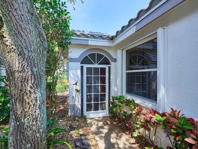 5455 S Fountains Dr S, Lake Worth, FL 33467 - view of exterior entry featuring stucco siding and a tile roof