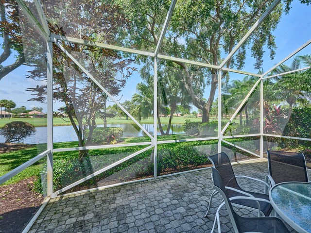 5455 S Fountains Dr S, Lake Worth, FL 33467 - unfurnished sunroom with a water view and outdoor dining area
