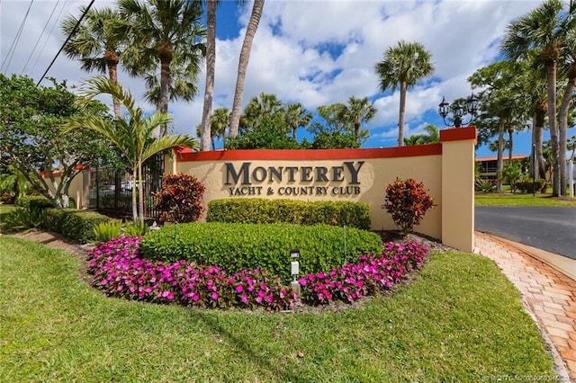 1925 SW Palm City Rd Unit C, Stuart, FL 34994 - community sign featuring a lawn and asphalt driveway