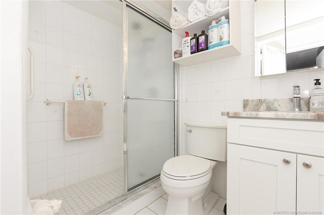 1925 SW Palm City Rd Unit C, Stuart, FL 34994 - full bathroom with tile walls, a shower stall, vanity, toilet, and tile patterned floors