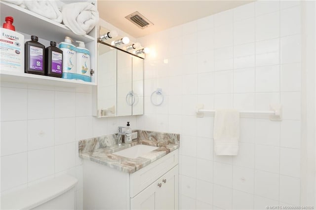 1925 SW Palm City Rd Unit C, Stuart, FL 34994 - half bath featuring tile walls, vanity, and toilet