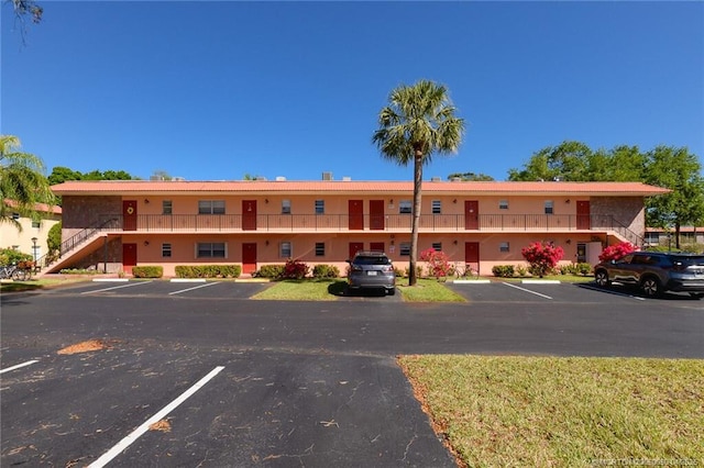 1925 SW Palm City Rd Unit C, Stuart, FL 34994 - view of building exterior with stairway and uncovered parking