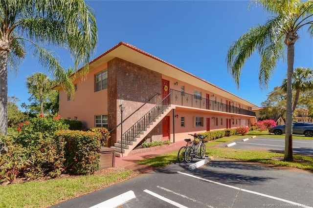1925 SW Palm City Rd Unit C, Stuart, FL 34994 - view of property featuring uncovered parking and stairs