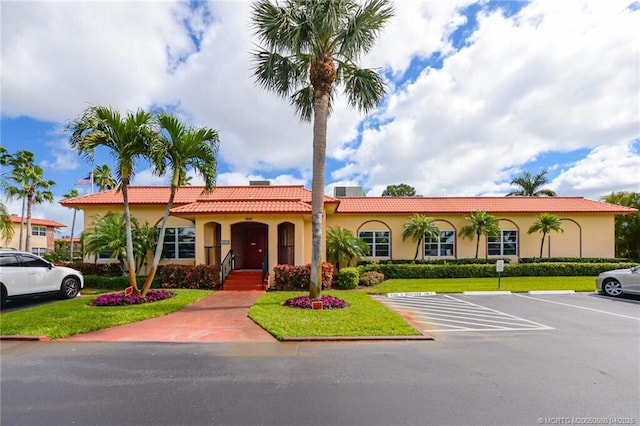 1925 SW Palm City Rd Unit C, Stuart, FL 34994 - mediterranean / spanish house with stucco siding, uncovered parking, a front yard, and a tile roof