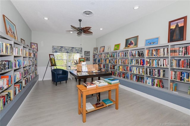 1925 SW Palm City Rd Unit C, Stuart, FL 34994 - office area featuring wall of books, wood finished floors, ceiling fan, baseboards, and recessed lighting