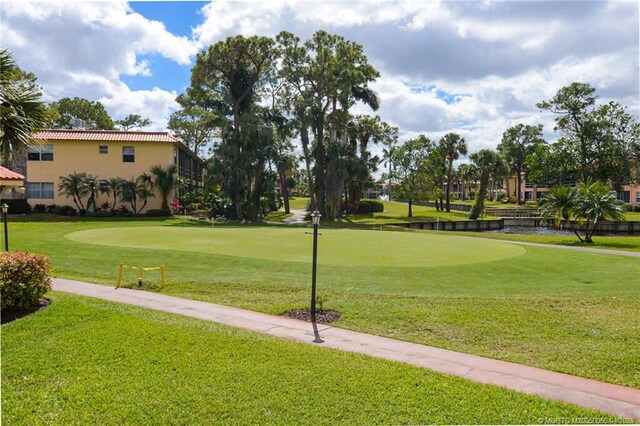 1925 SW Palm City Rd Unit C, Stuart, FL 34994 - view of community with a putting area, a lawn, and view of golf course