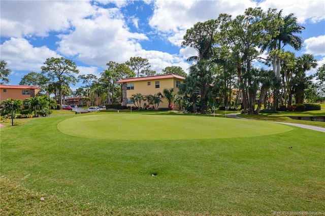 1925 SW Palm City Rd Unit C, Stuart, FL 34994 - surrounding community featuring a putting green, view of golf course, and a yard
