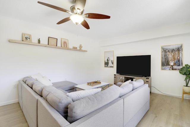 living room featuring a ceiling fan and light wood finished floors