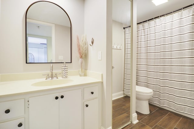 full bath with vanity, wood tiled floors, and toilet