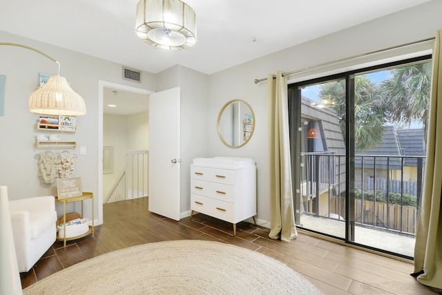 living area with wood finished floors, an upstairs landing, and baseboards