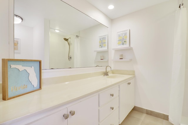 bathroom featuring tile patterned flooring, a shower with curtain, vanity, and baseboards