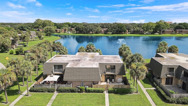 view from above of property featuring a nearby body of water and a tree filled landscape