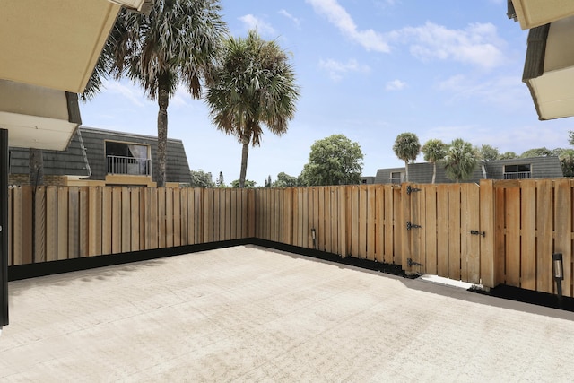 view of patio with fence and a gate