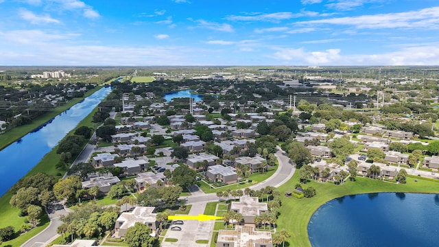 view of property location with a nearby body of water and nearby suburban area