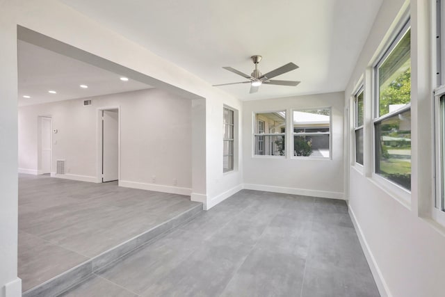 spare room featuring a ceiling fan, baseboards, and recessed lighting