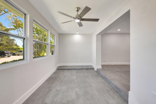 empty room with concrete floors, baseboards, recessed lighting, and a ceiling fan