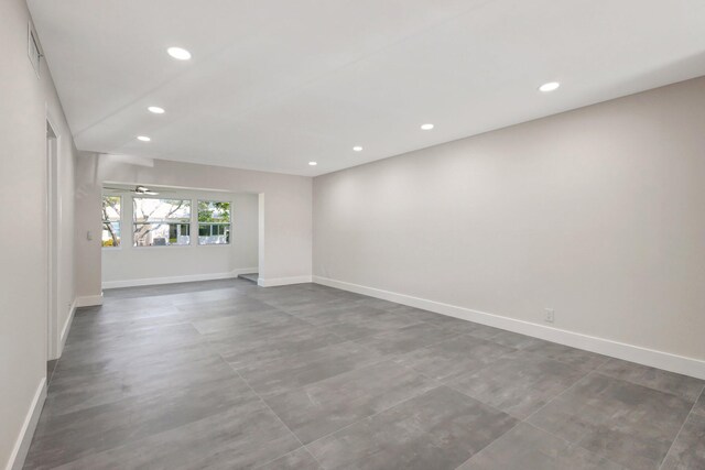 empty room with recessed lighting and baseboards