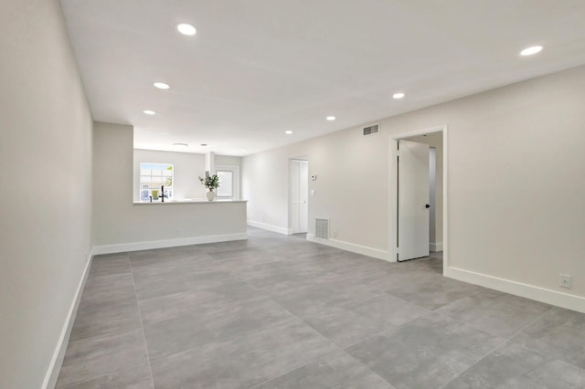 unfurnished room with recessed lighting, baseboards, and finished concrete floors