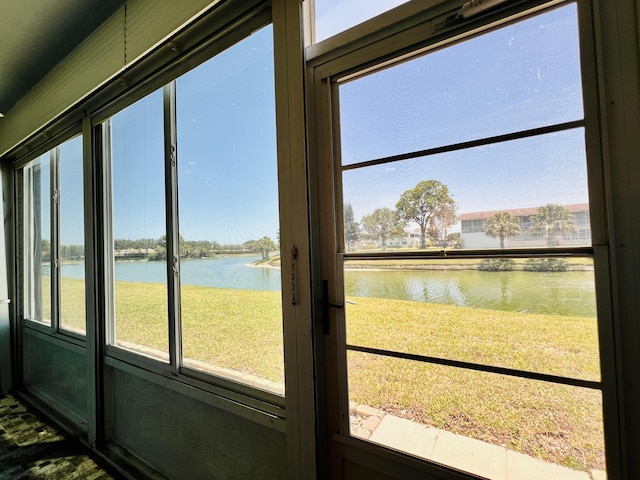 unfurnished sunroom featuring a water view