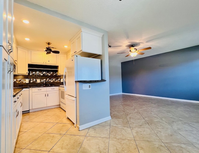 kitchen with ceiling fan, light tile patterned floors, backsplash, dark countertops, and white cabinetry