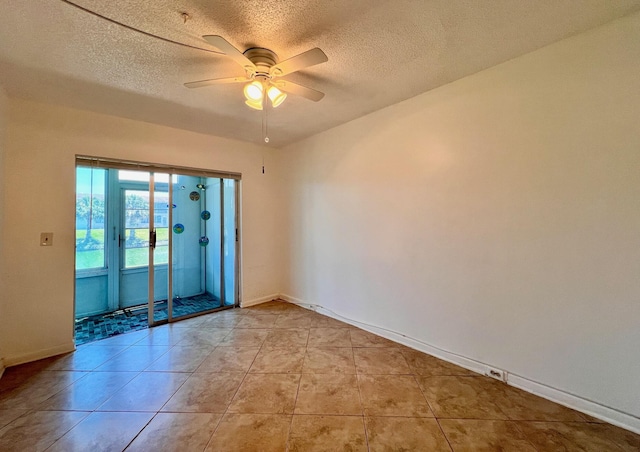 unfurnished room with a textured ceiling, ceiling fan, light tile patterned flooring, and baseboards