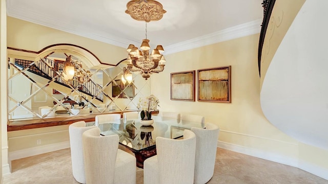 dining room featuring a chandelier, baseboards, and crown molding