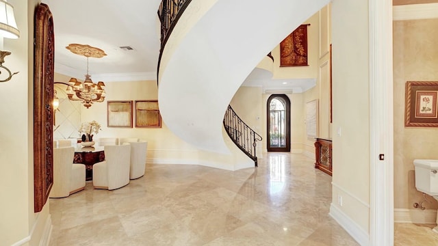 entrance foyer with arched walkways, marble tiled flooring, a chandelier, stairway, and ornamental molding
