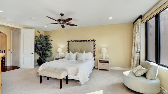 bedroom with arched walkways, a ceiling fan, baseboards, and recessed lighting