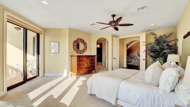 bedroom featuring arched walkways, access to exterior, baseboards, light colored carpet, and recessed lighting