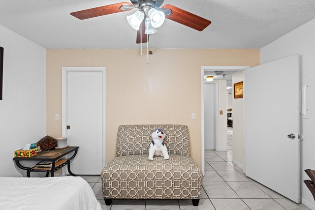 896 N Federal Hwy Unit 121, Lantana, FL 33462 - bedroom featuring a textured ceiling, light tile patterned floors, and a ceiling fan