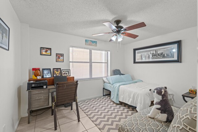 896 N Federal Hwy Unit 121, Lantana, FL 33462 - bedroom featuring baseboards, a textured ceiling, light tile patterned flooring, and ceiling fan