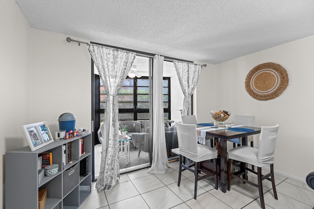 896 N Federal Hwy Unit 121, Lantana, FL 33462 - dining space with a textured ceiling, tile patterned flooring, and baseboards