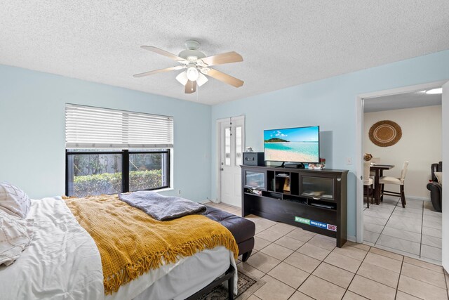 896 N Federal Hwy Unit 121, Lantana, FL 33462 - bedroom with light tile patterned floors, a ceiling fan, and a textured ceiling