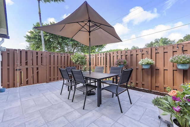 3839 Coco Loba Ln, Boynton Beach, FL 33436 - view of patio / terrace with a fenced backyard, outdoor dining space, and a gate