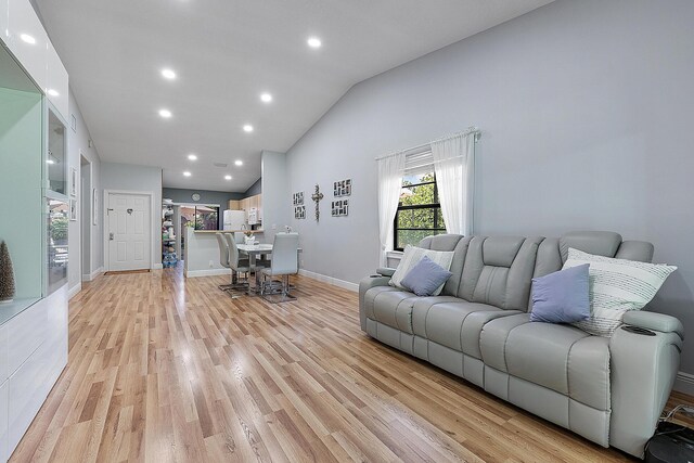 3839 Coco Loba Ln, Boynton Beach, FL 33436 - living area with light wood-style floors, recessed lighting, high vaulted ceiling, and baseboards