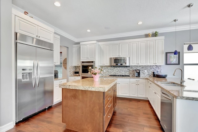 8979 Little Falls Way, Delray Beach, FL 33446 - kitchen with stainless steel appliances, a sink, decorative backsplash, dark wood-style floors, and ornamental molding