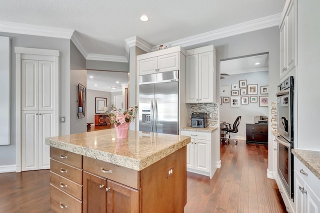8979 Little Falls Way, Delray Beach, FL 33446 - kitchen featuring stainless steel appliances, dark wood-style flooring, crown molding, a center island, and white cabinets