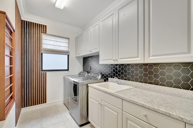 8979 Little Falls Way, Delray Beach, FL 33446 - washroom with cabinet space, independent washer and dryer, ornamental molding, baseboards, and light tile patterned floors