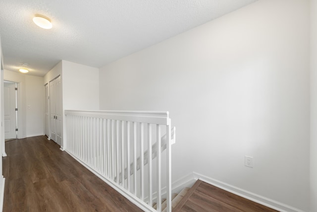 4718 NW 59th Mnr, Coconut Creek, FL 33073 - corridor featuring baseboards, wood finished floors, an upstairs landing, and a textured ceiling
